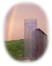 CoCoRaHS Image - Rainbow and Rain Gauge