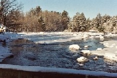 Photograph of river ice along the Black River in Boonville, NY in December 2002 looking upstream