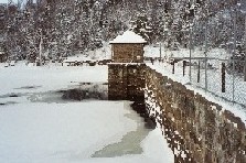Photograph of snow and river ice along the Indian River Dam near Indian Lake, NY (INDN6) looking downstream