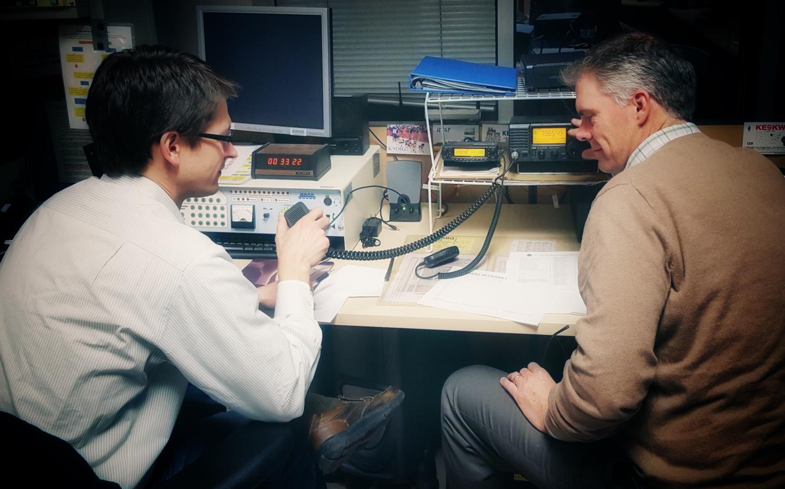 NWS meteorologists using amateur radio to contact SKYWARN spotters.