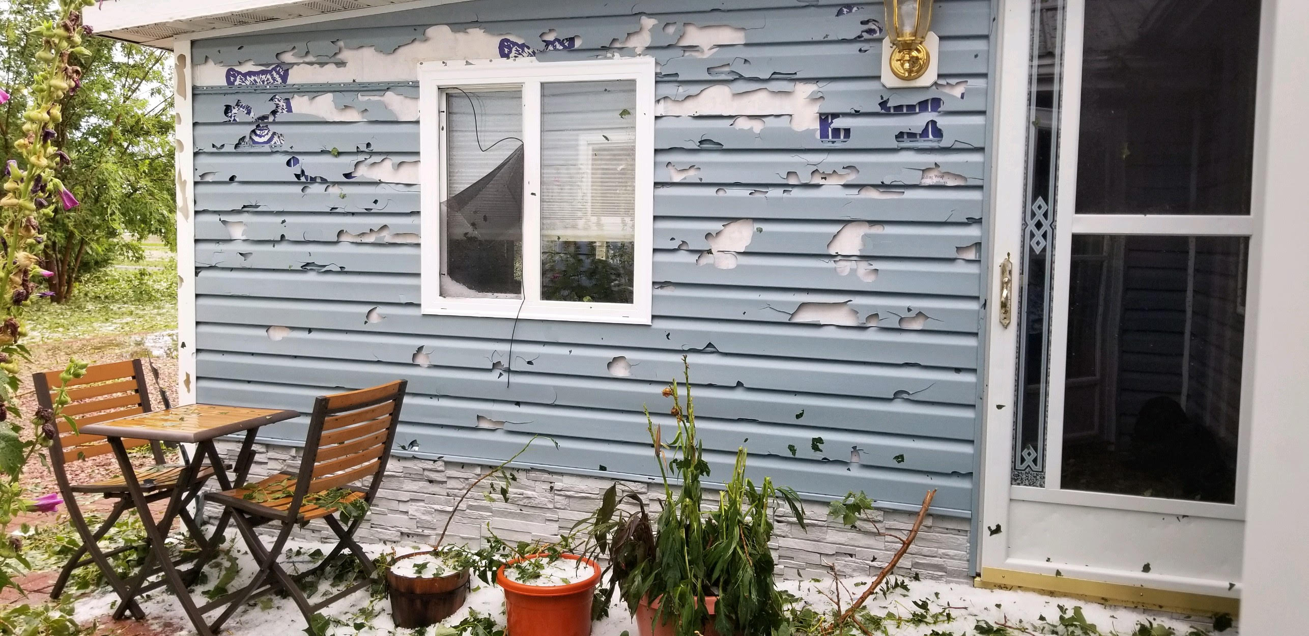 Whitlock Bay area - Hail damaged the siding of a house (Relayed from Edmunds County EM)