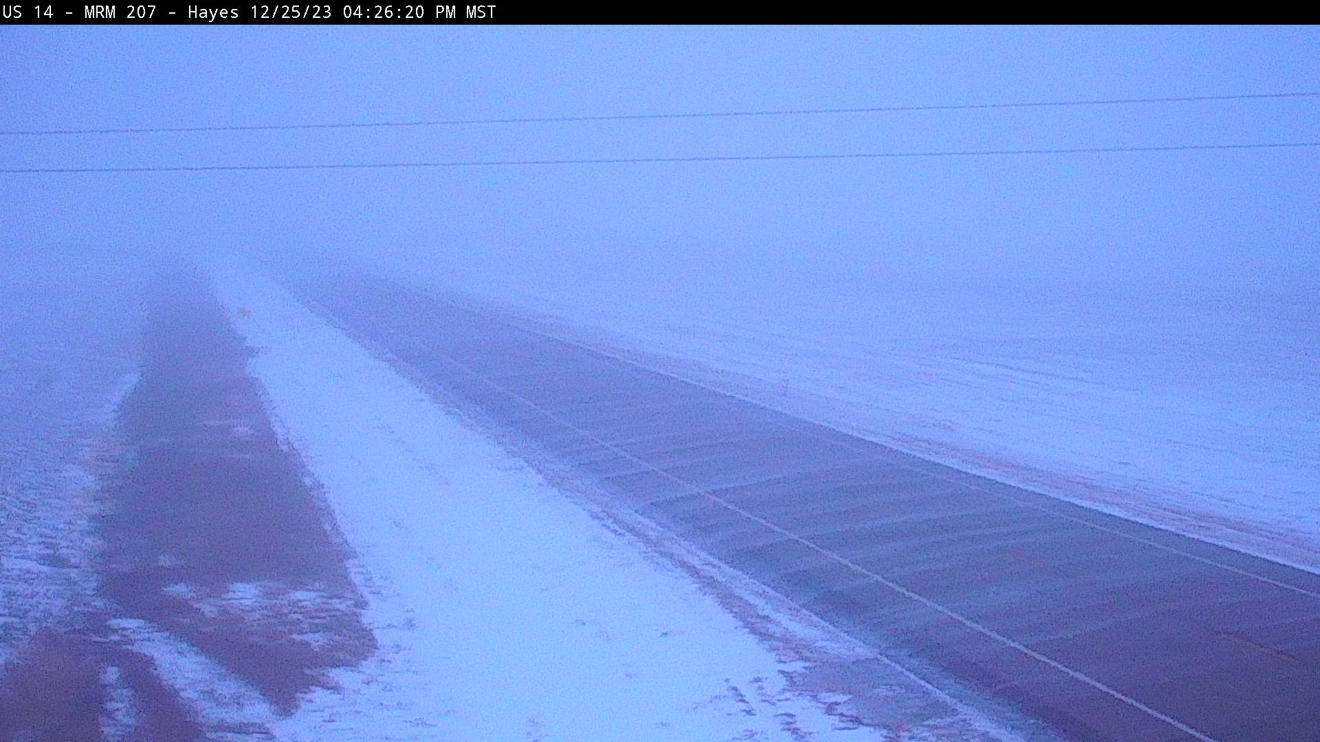 Falling snow and drifting snow across the road between Hayes and Pierre, SD at 5:26pm MST on December 25, 2023 (via SDDOT)