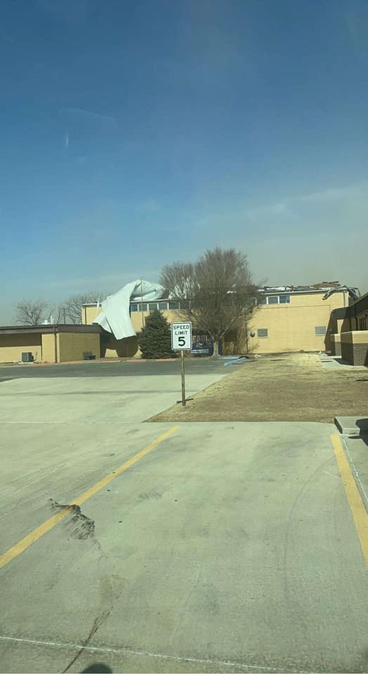 Photo by Jaci Lujan Quintana of a roof peeled back on the Goodwell, Oklahoma school gym due to high winds on Feburary 14th, 2023