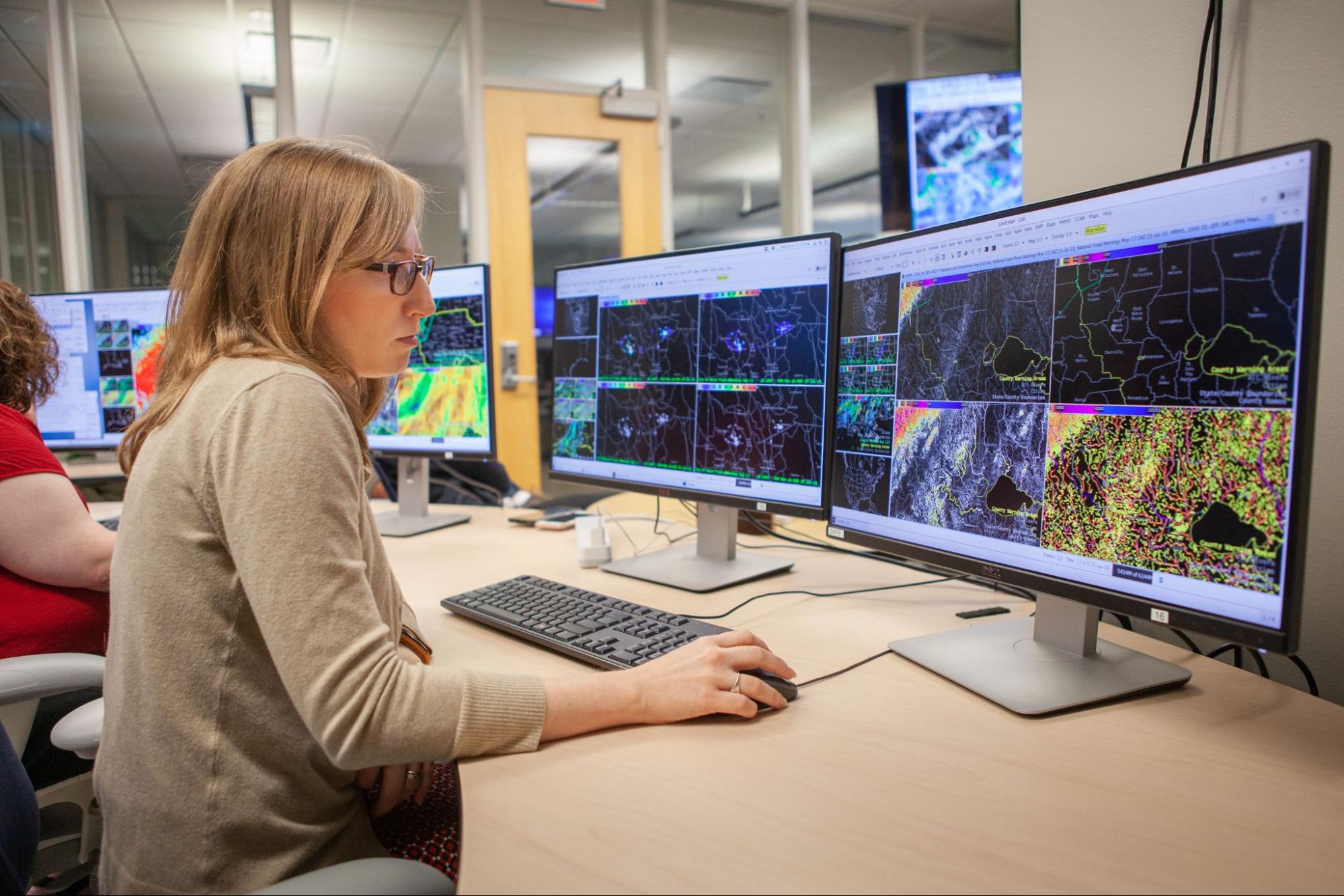 NWS employee working at a computer