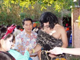 NWS Brownsville Information Technology Officer Toan Tran and Warning Coordination Meteorologist 'Caveman' Barry Goldsmith handing out candy and NWS information at Boo at the Zoo, Brownsville, TX, in 2009