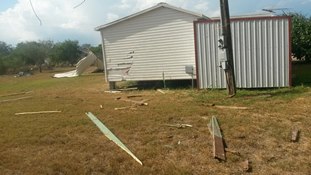 Damage to mobile home porch overhang near Edinburg, TX during late afternoon, August 13, 2014