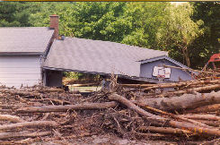 house with flood damage and debris