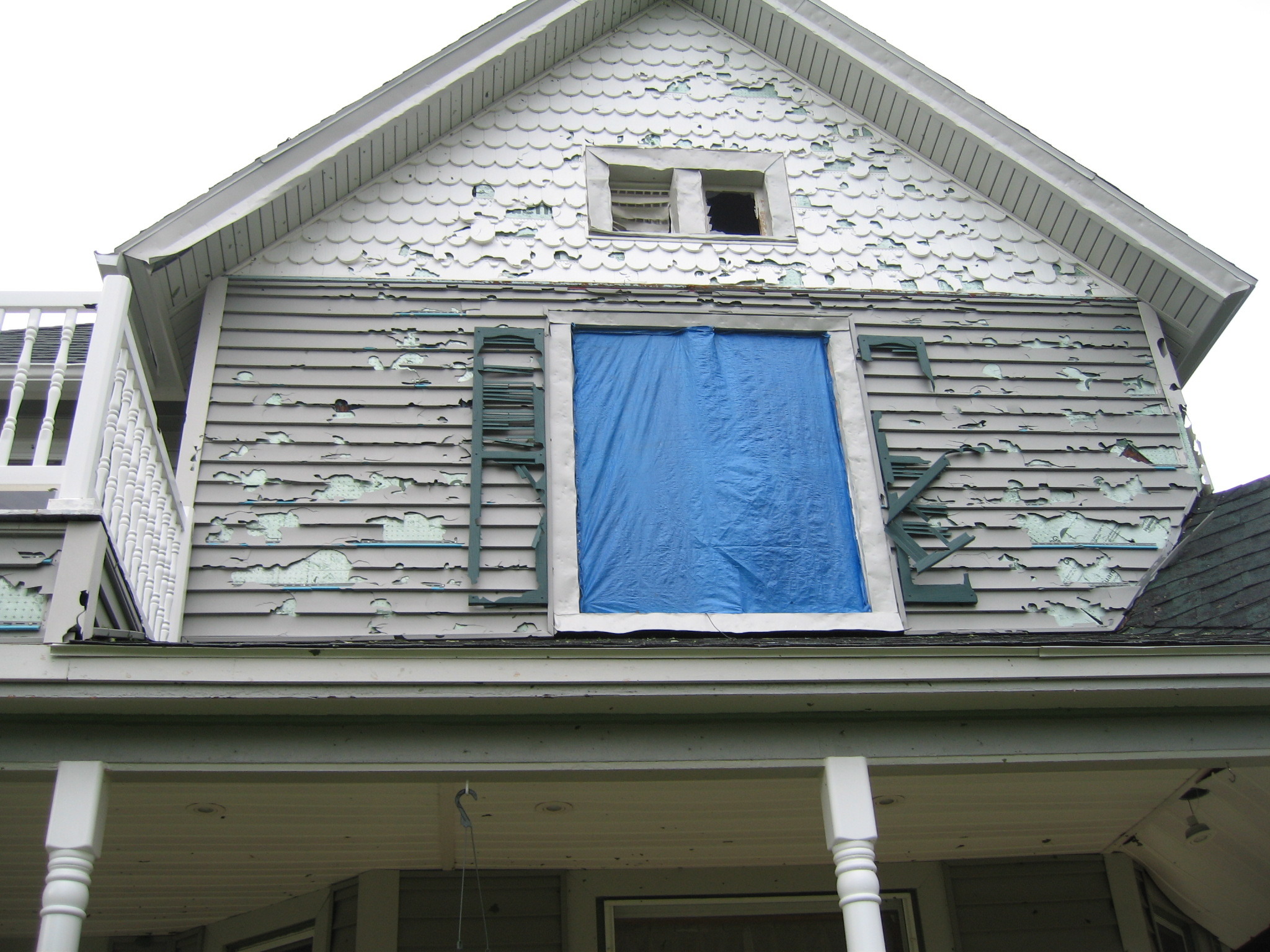 Siding damage from wind-driven hail in Eldora