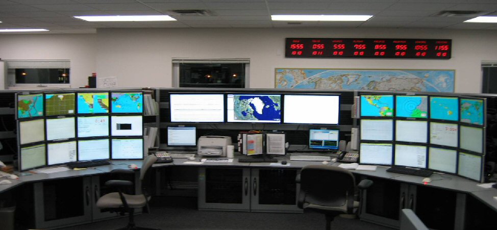 Image of Warning Center showing computer displays of weather data and maps. - NOAA Image