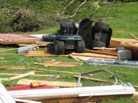 [ Riding lawnmower flipped over among debris. ]