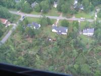[ aerial view of trees down and houses damaged ]