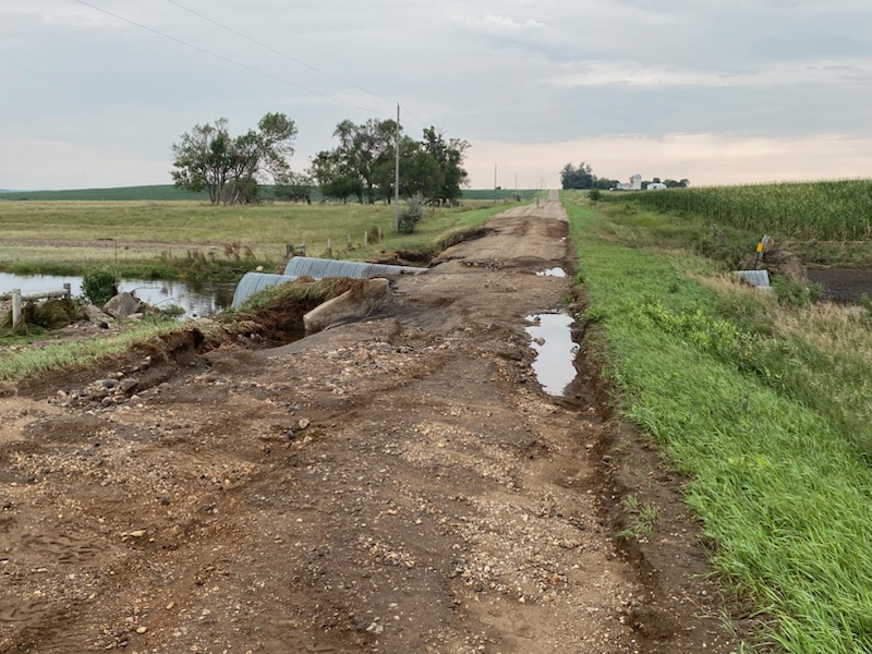 A local road north of De Smet, South Dakota was mostly washed out exposing two culverts on one side of the left side of the road. Further past the culverts, additional damage occurred. 