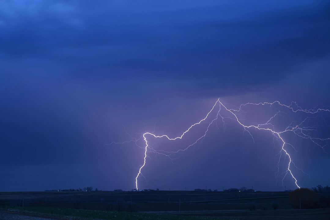 Photo of 2 branches of cloud to ground lightning near Le Mars, Iowa