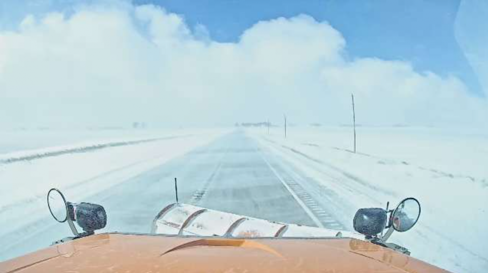 IADOT snowplow camera shows low visibility due to blowing snow east of Cleghorn, IA at 11:30 AM March 5th, 2025.