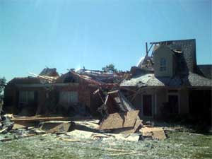 Picture of a home that was damaged by a tornado near Cash, Texas