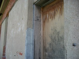 Close up of Door on Old Light and Power Building in Arapahoe, NE with High Water Mark