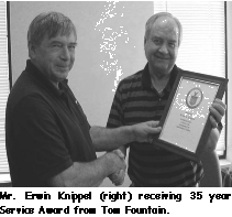 A picture of Mr Erwin Knippel receiving a 35 year service award from Tom.