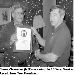 A picture of Mr James Chancellor receiving a 15 year service award from Tom.