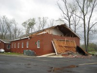 The front of this church sustained considerable damage in the tornado. The roof was damaged and, the steeple was blown off.