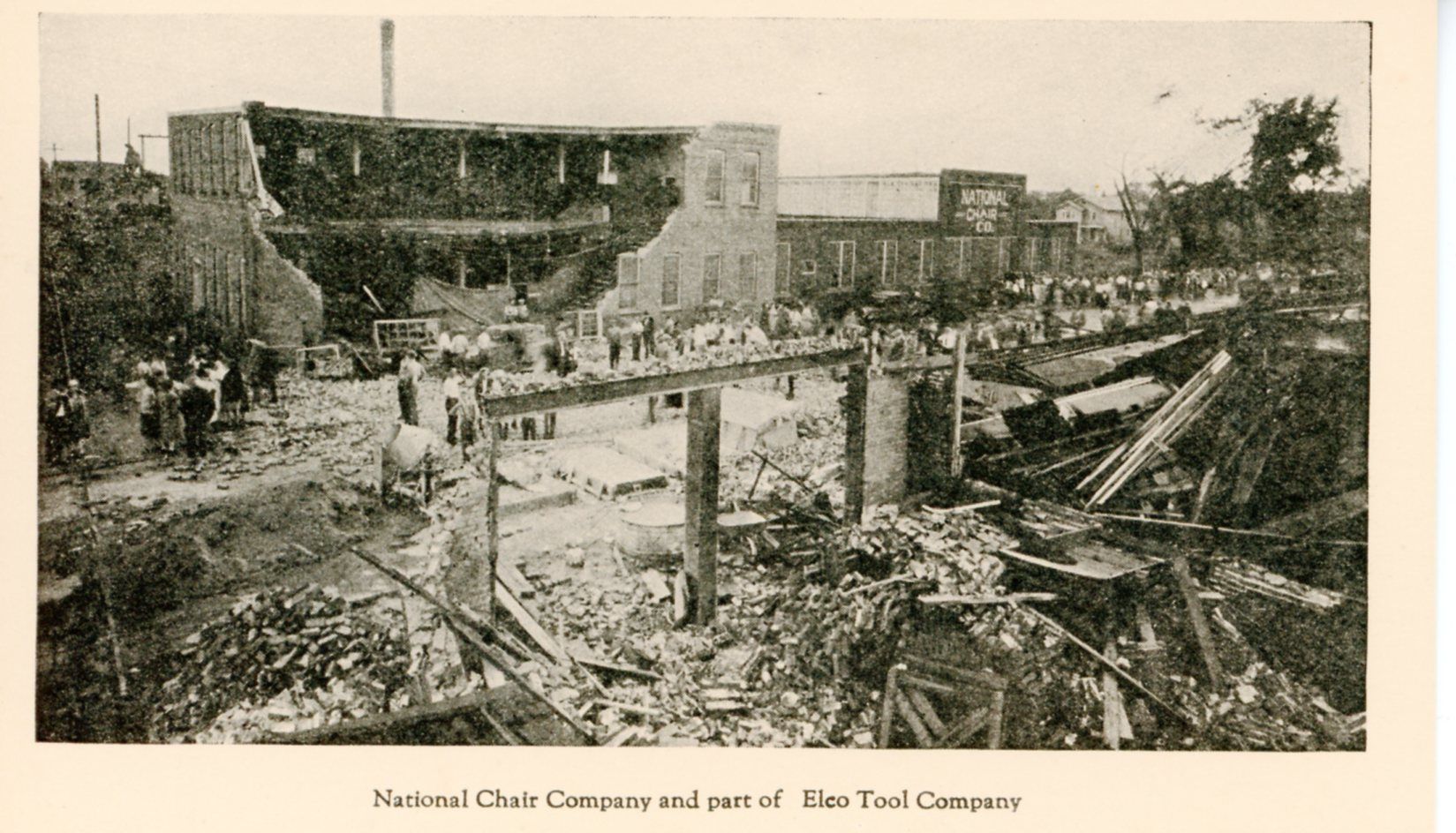 Damage to Elco Tool and National Furniture Company. Photo shows the roof and multiple walls collapsed in the foreground and another building in the background with the front wall collapsed.