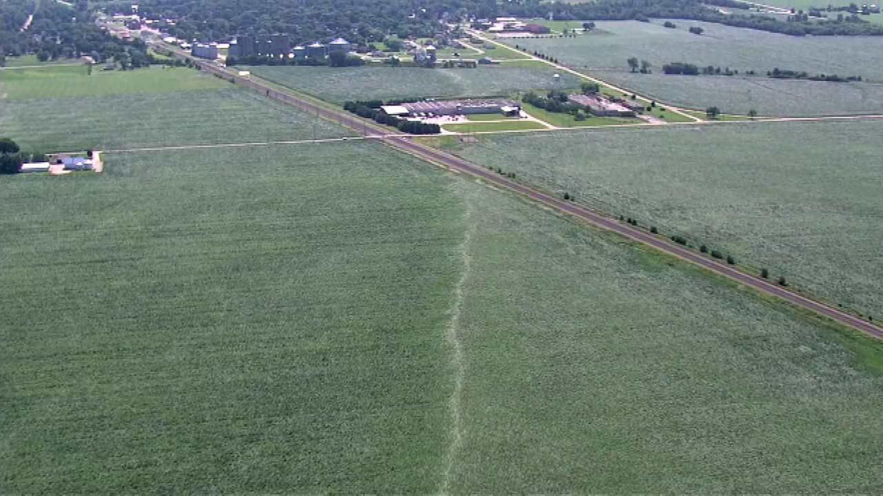 Photo showing damage from a tornado near Earlville. Aerial imagery shows a convergent path in a field.