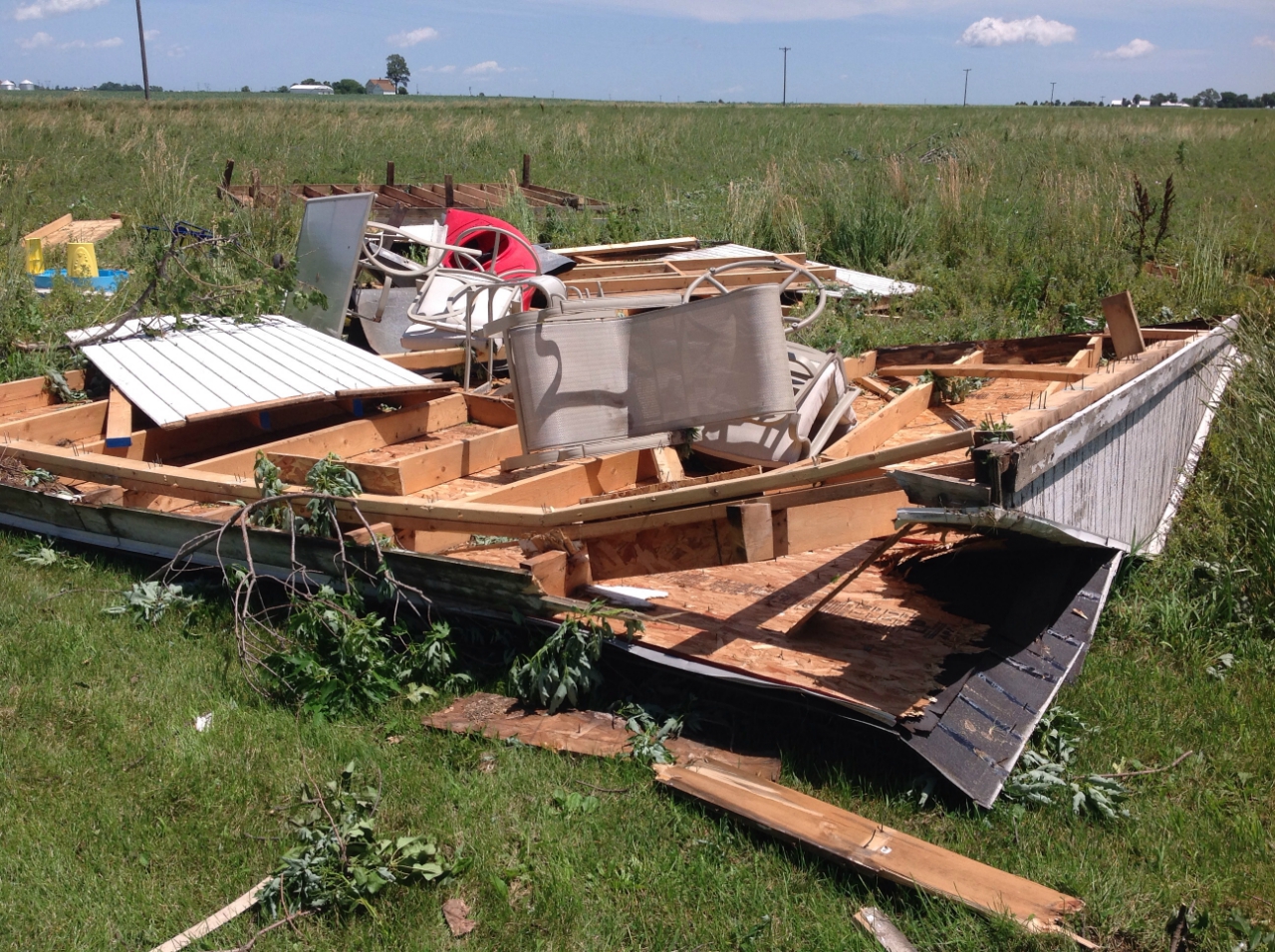 Photo showing damage from a tornado near Grant Park. A shed has been destroyed with only the foundation remaining.