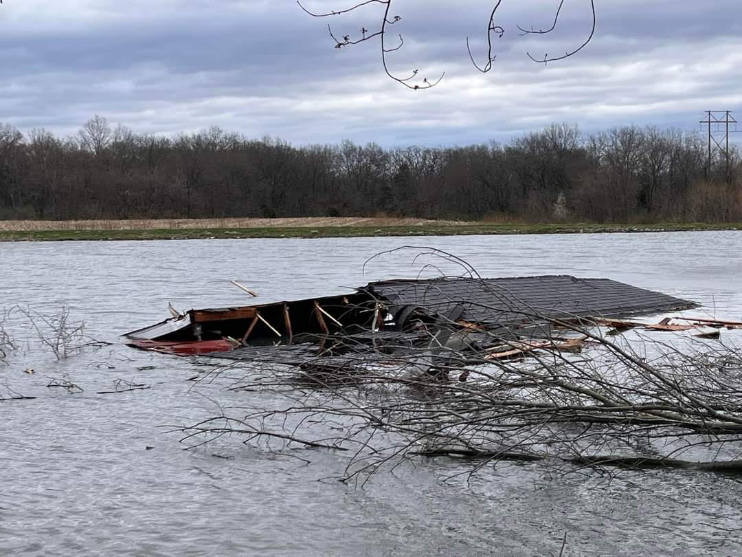 The roof of a garage was torn off and thrown into a nearby body of water by straight-line winds in Prairietown, IL. (Amy Roe)