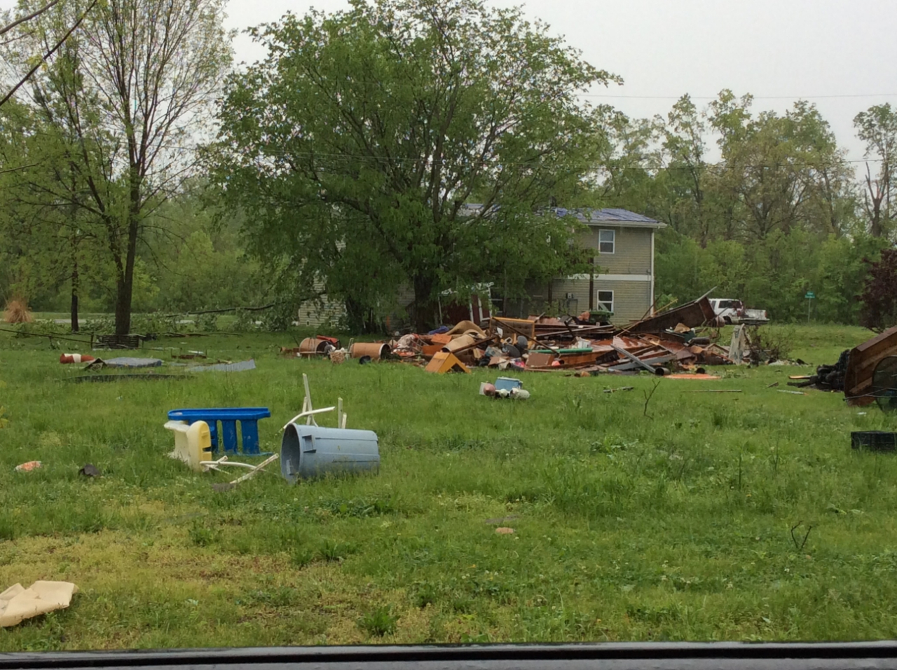 Photo of outbuilding/shed was destroyed with debris pushed to the northeast.