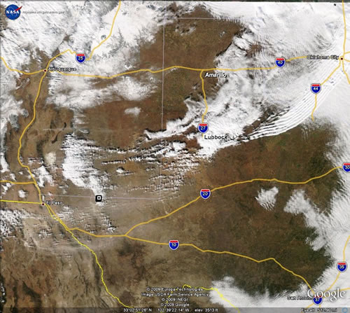 Enhanced MOSDIS aqua satellite imagery from the afternoon of December 8, 2009. The white represents areas of clouds and snow, with the brown swath from Mexico and Far West Texas into the Permian Basin and South Plains being blowing dust. Click on the image for a larger view.