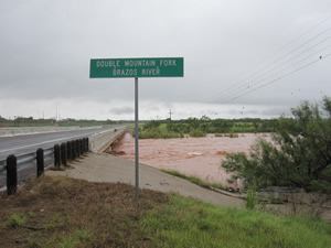 The swollen Double Mountain fork of the Brazos flowing under the bridge near Justiceburg