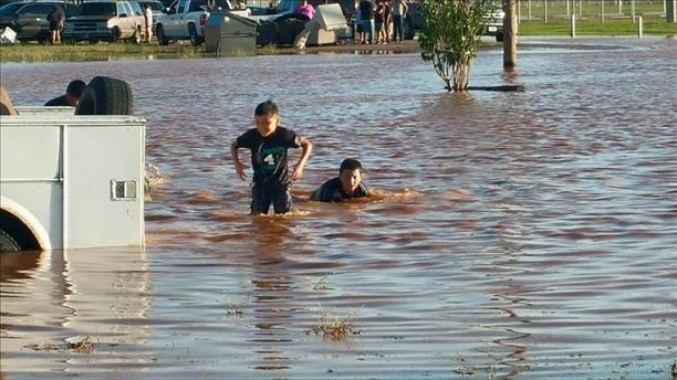 Picture of inundation flooding and kids having fun in the water at Seagraves (courtesy of Delia Benny Arriaga and KCBD). 