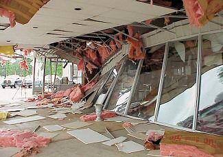 A sales building at an auto dealership was heavily damaged in Benton (Saline County).