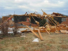 A tornado removed most of the roof and removed brick from outer walls near Chickalah (Yell County) on 01/12/2006.