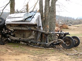 A pickup truck was thrown into a tree and stripped...and became almost unrecognizable.