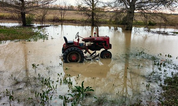 After rain ended, a tractor sat in a flooded yard near Tyronza (Poinsett County) on 04/01/2016.