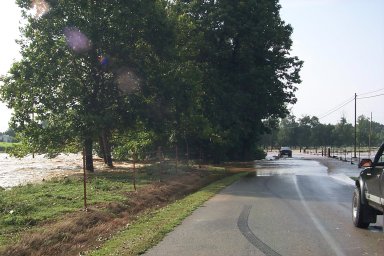 View of flooded Horse Creek overflowing across a road