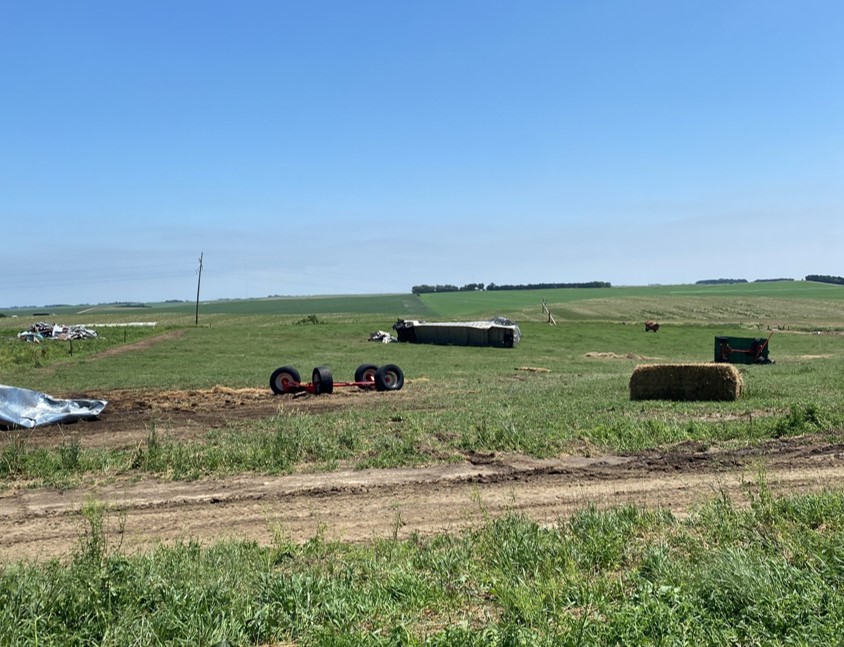 Cattle truck thrown and various farm equipment tossed around.