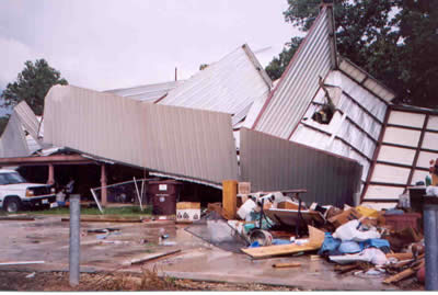 Boat storage building tossed onto a residence near Quitman, TX