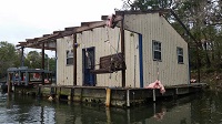 Damage to a building on the banks of the Apalachicola River caused by an EF1 tornado that crossed the river on November 17, 2014. Photo provided courtesy of WJHG-TV.