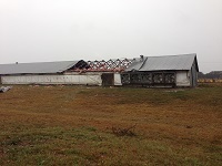 Damage to the roof of a chicken coop caused by severe thunderstorm wind gusts near Lee in Madison County, FL on November 17, 2014.