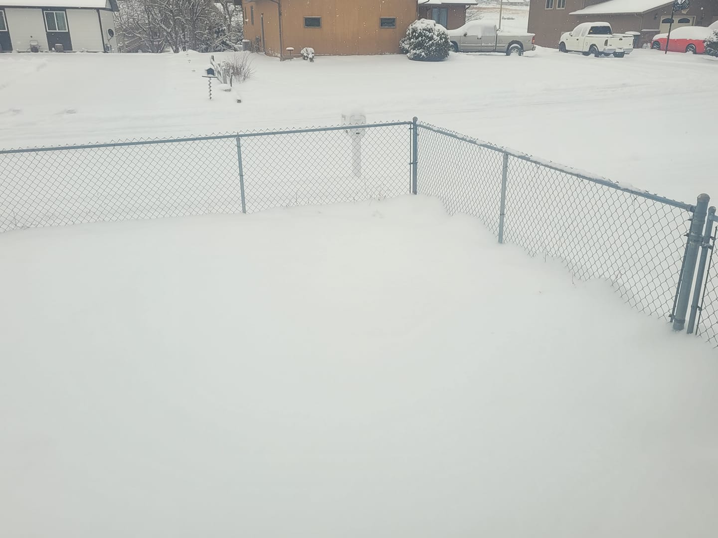 Fence with heavy snowfall around it
