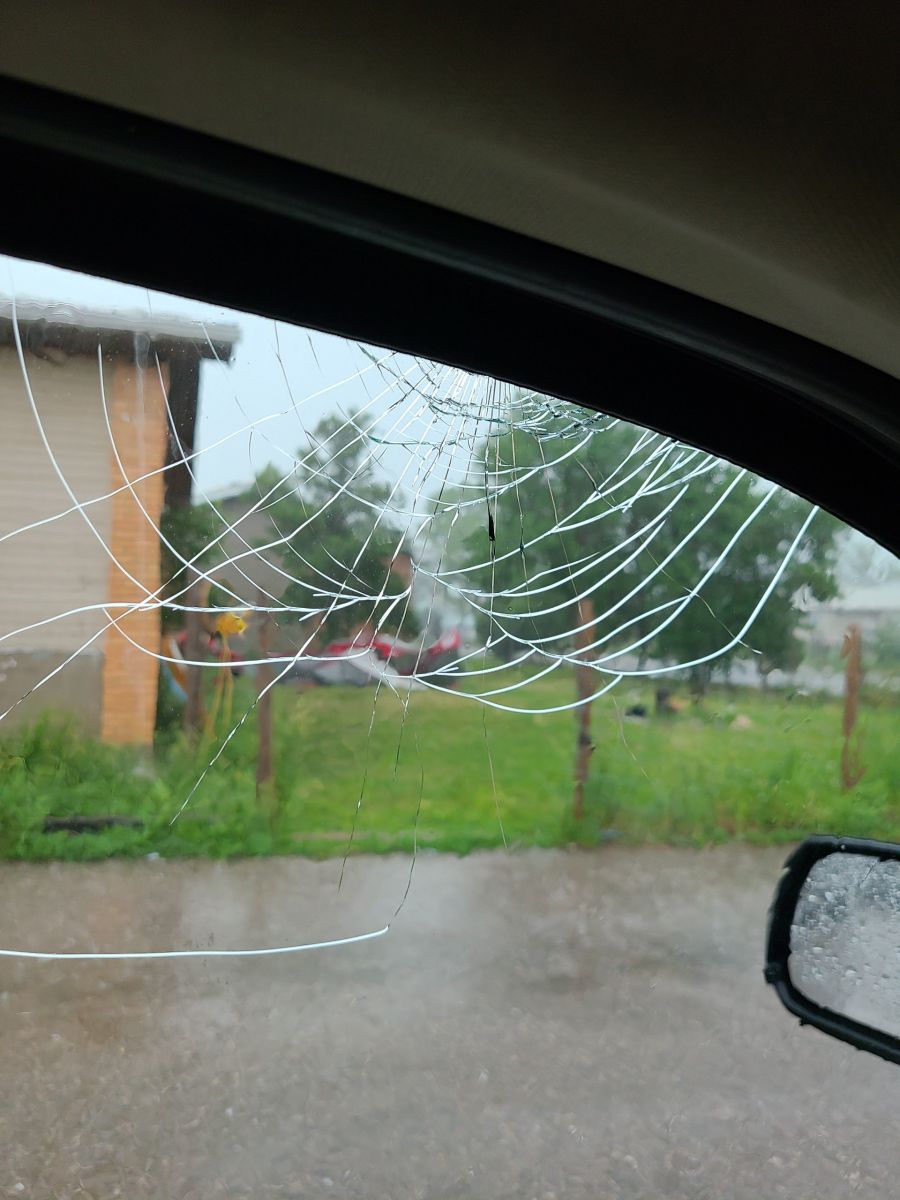 Broken driver side window due to baseball size hail
